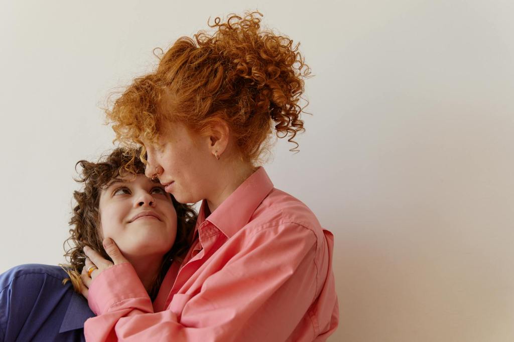 women in dress shirts looking happily at each other